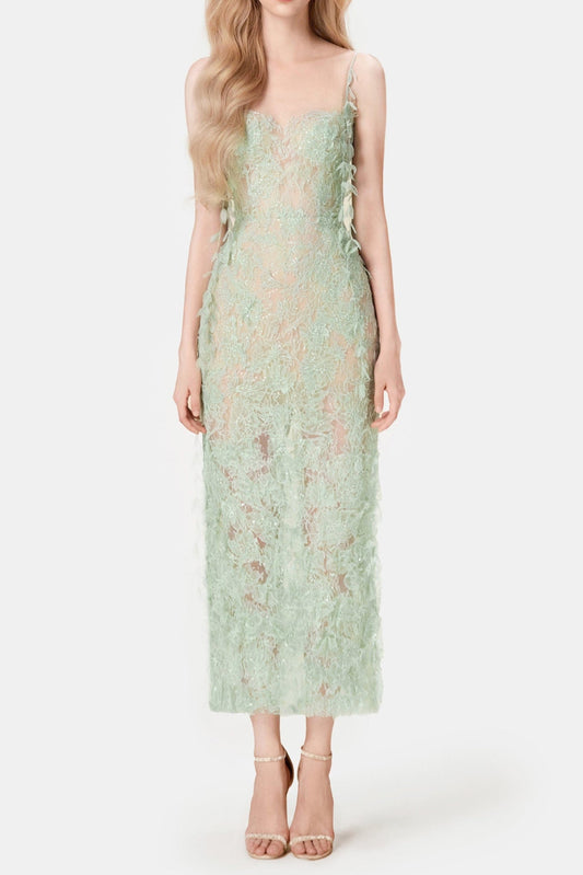 Woman wearing a light green lace dress on a white background