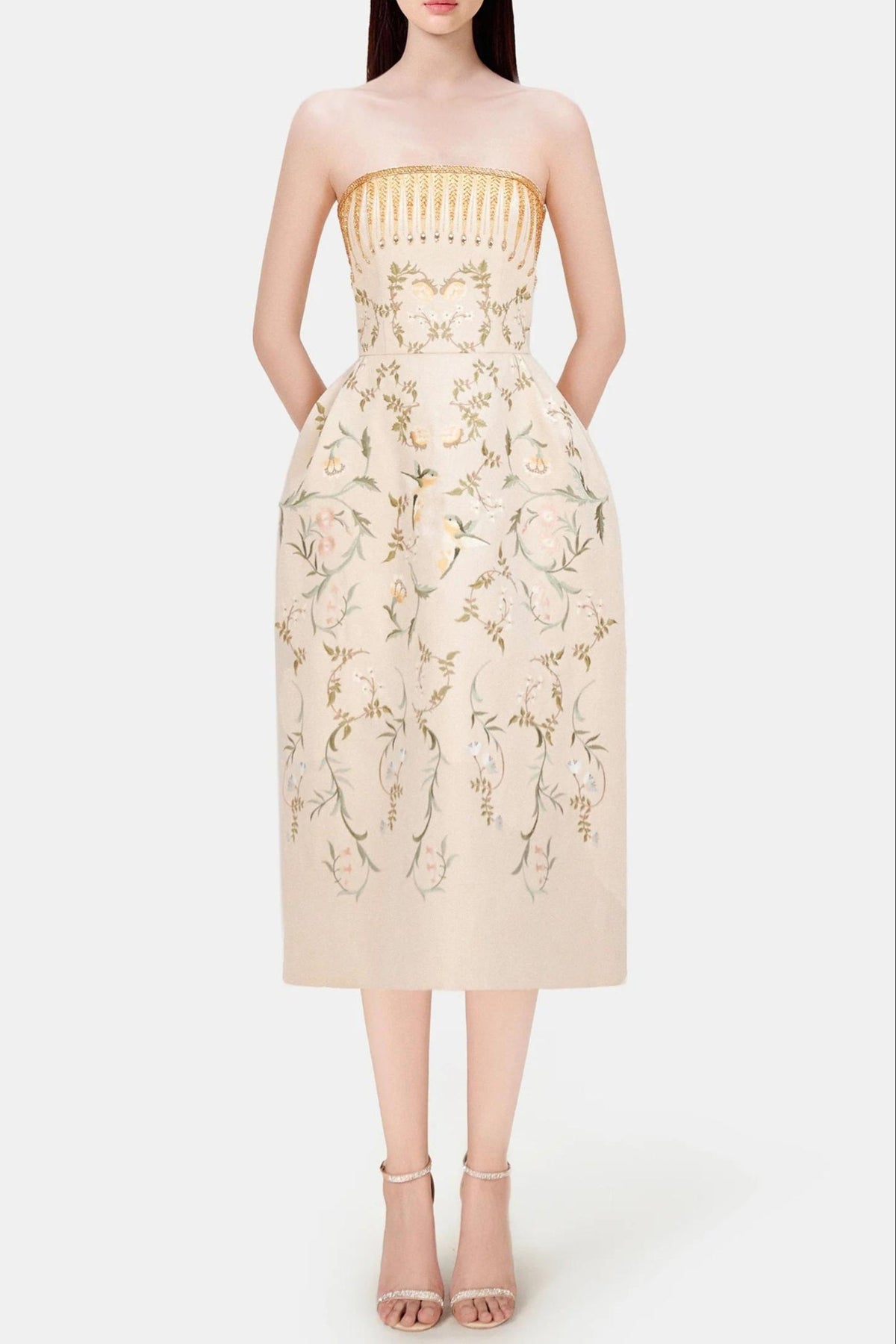 Beige strapless dress with floral embroidery on a white background