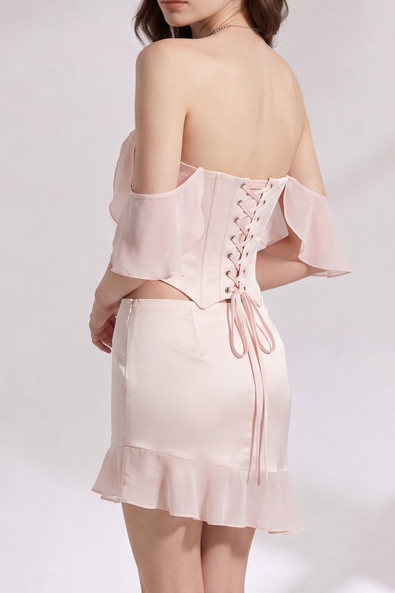 Pale pink Satin Fitted corset bodice with off-the-shoulder sleeves; fitted mini skirt with ruffled hem Two-piece set (corset top and mini skirt) Pale pink Satin Two-piece set (corset top and mini skirt) - product view 1