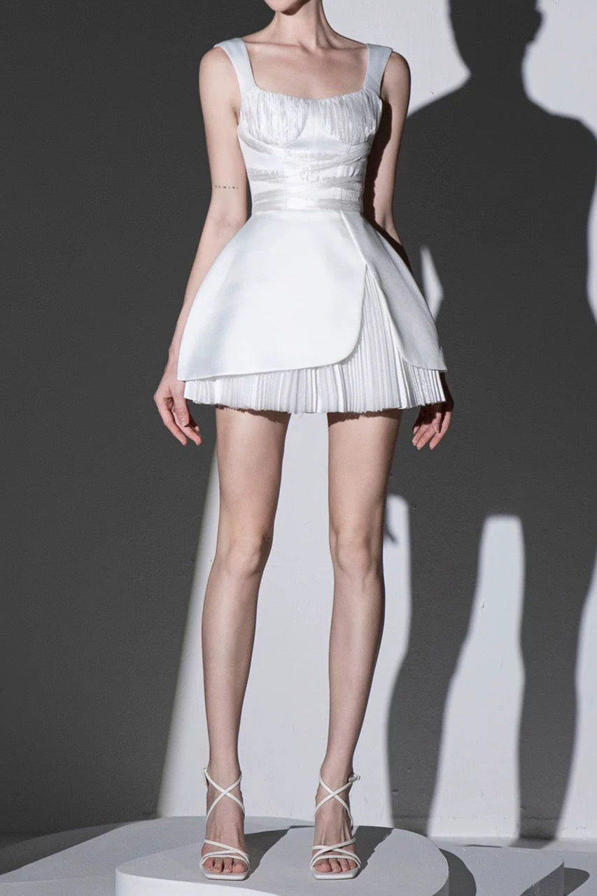 Model wearing a white dress on a gray background