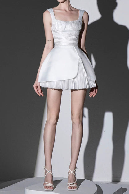 Model wearing a white dress on a gray background
