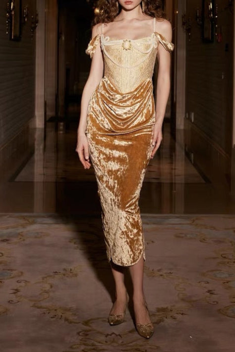 Woman wearing a gold and brown dress in an indoor setting