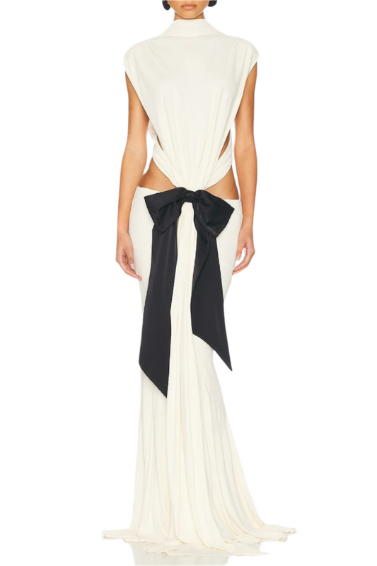 A backless white maxi dress with bow cutouts on the back, made from cotton fabric.