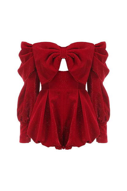 Red velvet top with a large bow on a white background