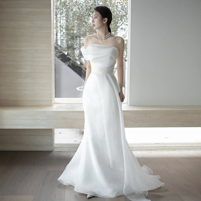 Lisa in a simple yet elegant white French-style one-shoulder mermaid Maxi Dress