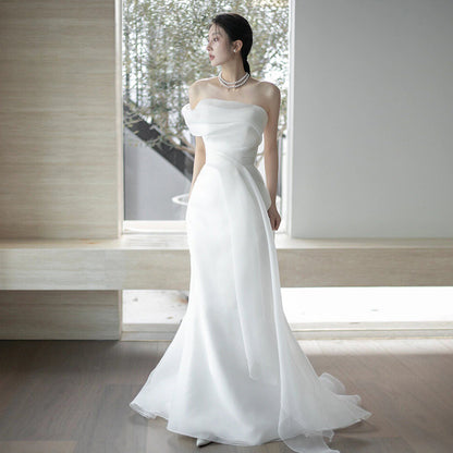 Lisa in a simple yet elegant white French-style one-shoulder mermaid Maxi Dress
