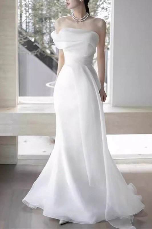 Lisa in a simple yet elegant white French-style one-shoulder mermaid Maxi Dress