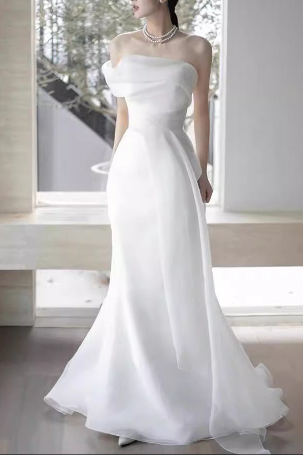 Lisa in a simple yet elegant white French-style one-shoulder mermaid Maxi Dress