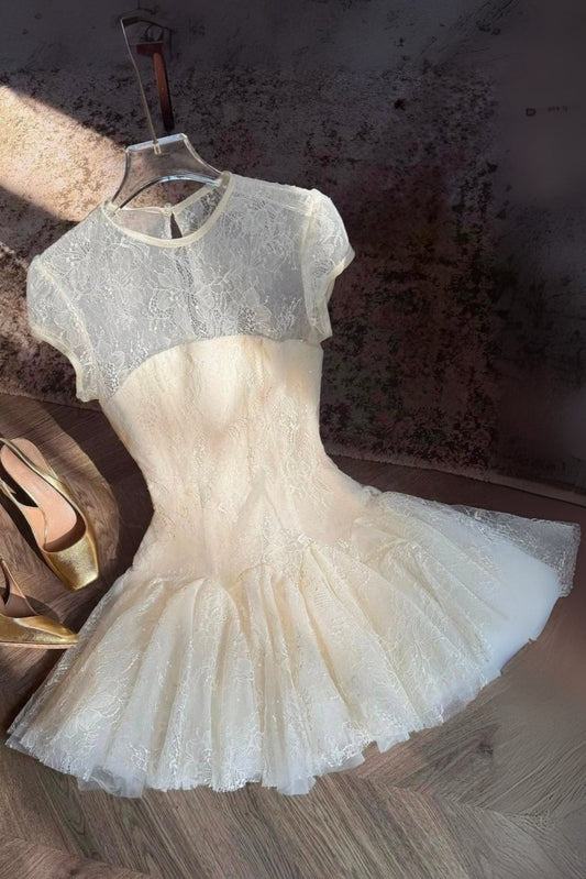 White lace dress with gold shoes on a textured surface