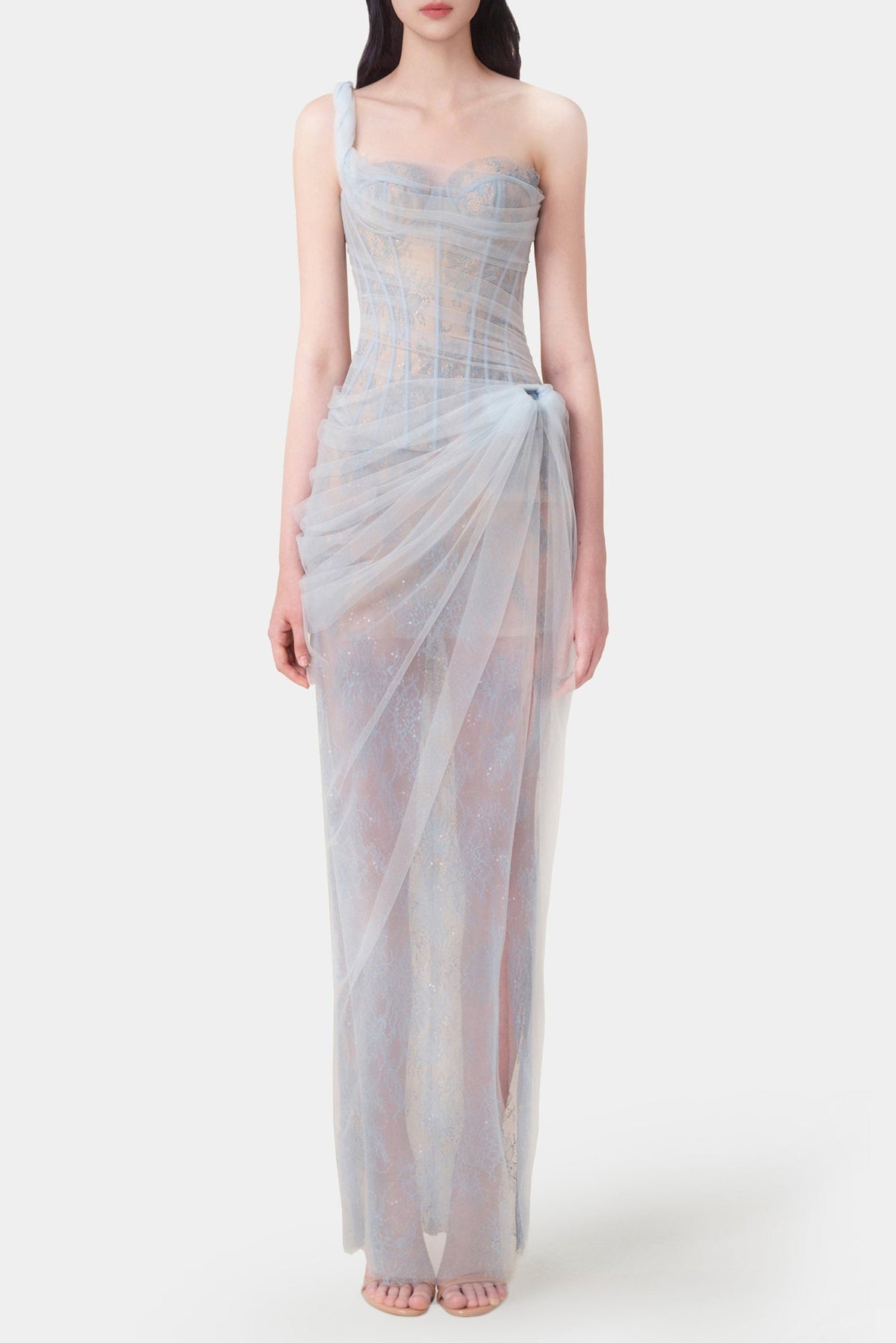 Woman wearing a light blue strapless gown on a white background